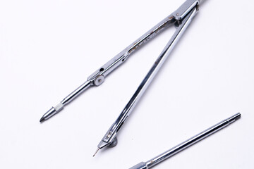 Silver Drawing Compass on White Background, Precision Instrument for Geometry and Design.
