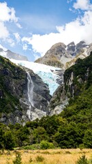 Glacier waterfall cascading down rocky mountains