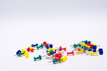 Colorful Push Pins Scattered on White Background, Office Supplies, Stationery.
