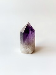 Fototapeta premium Amethyst crystal isolated on white background, showcasing natural color gradient and geometric shape.