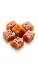 Close-up shot of delicious, golden-brown square caramel candies. 
