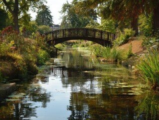 Fototapeta premium Serene Wooden Bridge Over a Canal in a Lush Park