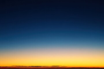 Obraz premium Blurry sunset sky, dark blue fading to orange