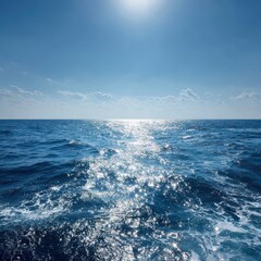 Vast blue ocean with sparkling sun reflections under a bright sky