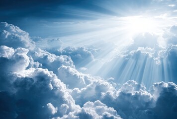 A radiant sunbeam filters through fluffy, billowing clouds in a bright, blue sky creating a sense of hope and ethereal beauty