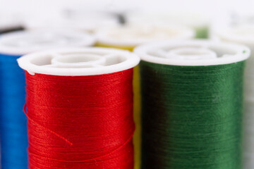 Colorful Thread Spools - Red, Green, and Blue Sewing Supplies Close-Up.