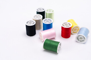 Colorful Thread Spools on White Background - Sewing and Craft Supplies.