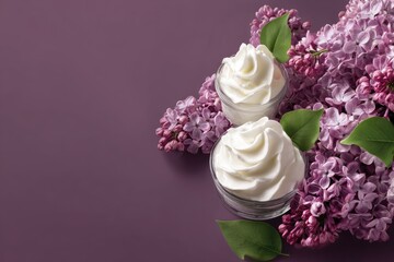Two small glass dishes of whipped cream, surrounded by lilac blossoms, on a purple background