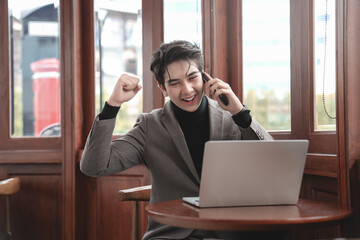 Happy Businessman Celebrating Success While Making Phone Call