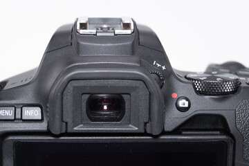 Close-up of a Black Digital Camera Body with Viewfinder and Controls on White Background.