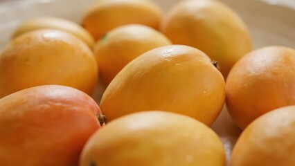 A pile of tempting mangoes with plump fruits shows freshness and deliciousness.