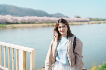 Woman tourist sightseeing Kitakami Tenshochi Park with Sakura Cherry Blossom in Spring, traveler travel in Kitakami festival, Iwate prefecture, Japan. Landmark for Travel and Vacation destination
