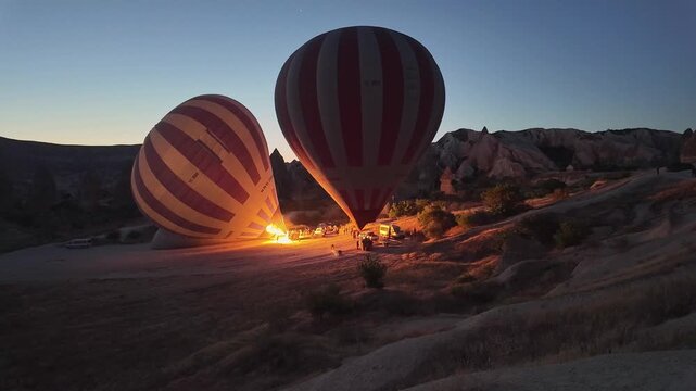 Preparing hot air balloons for romantic honeymoon tour over Cappadocia, Turkey