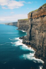 Obraz premium Rugged cliffs meet turquoise ocean waves water