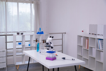 Learning and education for student in classroom guided by teacher instruction, training with pipette and concentration during observation of sample under microscope in structured laboratory experiment