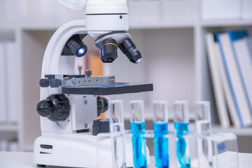 Learning and education for student in classroom under guidance of teacher, experiment uses scientific equipment showing test tube, beaker, droppers, microscope for chemistry analysis, biology research