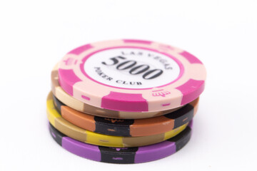 Stack of Colorful Casino Poker Chips on White Background, Gambling Concept, Close-Up.