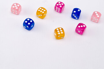 Colorful Dice Arrangement on White Background - Pink, Blue, and Yellow Game Pieces.