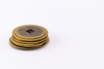 Stack of Antique Chinese Coins with Square Hole on White Background, Close-Up.