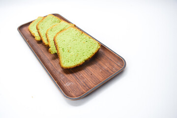 Kue bolu or simply bolu is an Indonesian term that describes a wide variety of sponge cakes, tarts and cupcakes. Green sponge cake with white background