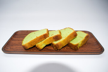 Kue bolu or simply bolu is an Indonesian term that describes a wide variety of sponge cakes, tarts and cupcakes. Green sponge cake with white background