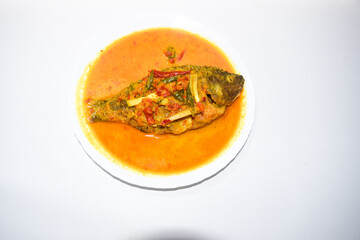 Ikan Nila bumbu kuning, Traditional Menu from West Indonesia, Made from Fried Tilapia and yellow sauce made from turmeric
