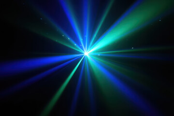Obraz premium Bright blue and green laser light beams emanating from a central starburst on a
