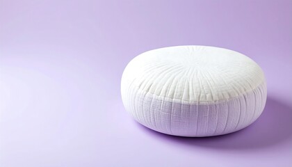 Cozy white floor pouf on a soft lavender background creates a tranquil and inviting modern living space.