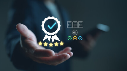 Businessman hand showing quality assurance icon with certification, ISO standard, five stars, and...