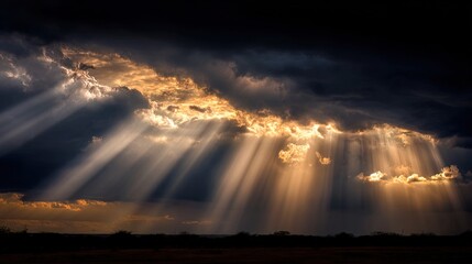 A dramatic sky features dark clouds illuminated by beams of sunlight breaking through, creating a captivating and serene atmosphere.