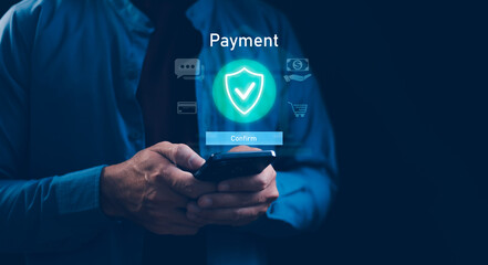 Businessman using a smartphone for secure online payment, featuring a glowing shield icon and...