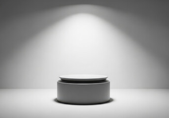 Empty pedestal illuminated by a spotlight in a minimalist studio