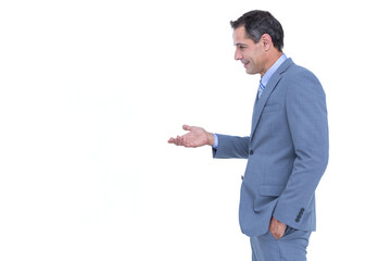 Mature man in blue suit standing in profile, gesturing with palm up in studio, copy space
