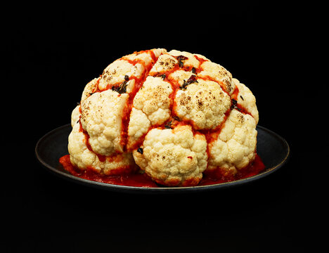 Cauliflower Brain with Sauce on Black Background
