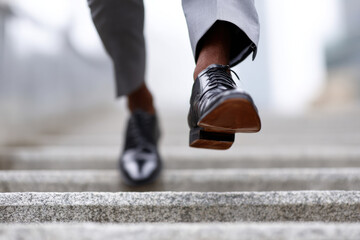 Businessman running upstairs symbolizing success