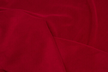 Fleece fabric red top view. Texture of textile fleece bedspread.