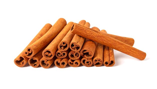 Stacked cinnamon sticks against white