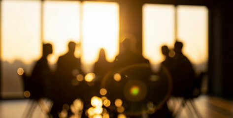 Silhouetted people sit at a table in a brightly lit room with warm sunlight streaming through large windows, creating a dynamic atmosphere of teamwork and connection.