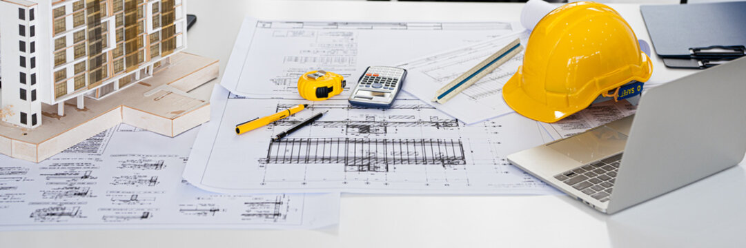 Architect or engineer professional. blueprint , structual  floor plans   with  a pencil,  triangular scale , Shop drawing ,  calculator,  laptop and engineering tools.