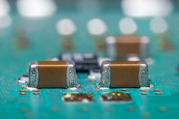 Close up view of brown surface mounted devices on electronic printed circuit board.