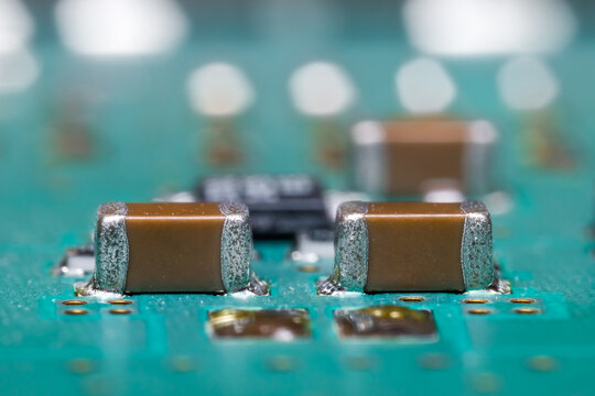 Close up view of brown surface mounted devices on electronic printed circuit board.