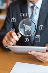Naklejka premium Professional Businessman Using Digital Tablet with Magnifying Glass on E-commerce Icons Modern Connected Commerce Insights for Marketing and Advertising