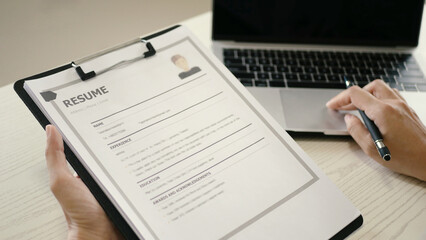 The young businesswoman was very committed and dedicated to her work and really wanted new employees to join her team. She read the resume and stood up to select new employees