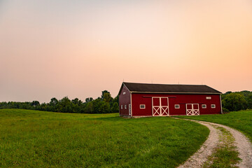 rural landscape with barn during a hazy sunset