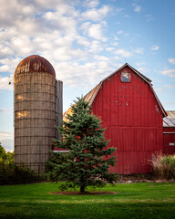 red barn and silo in the country on a beautiful evening © Christopher