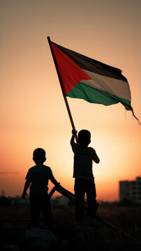 Silhouette of children holding a palestine flag against a sunset sky view