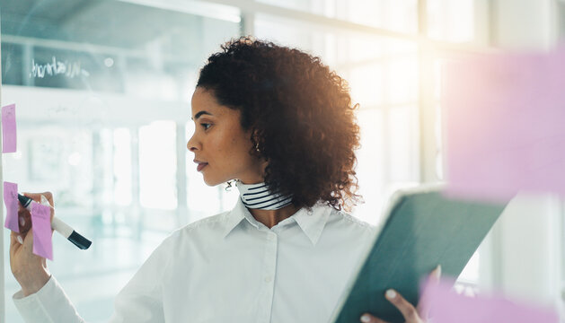 Fashion, brainstorming and woman in office with sticky note, creativity and writing for trend report. Ideas, market research and designer in workplace with tech, vision and agenda for style analysis.