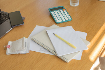 Home office workspace with notebooks, calculator and smartphone. Accounts, taxes and budget.