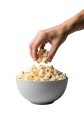 Adult human hand reaching into a white bowl of fluffy popcorn with salt crystals, focused against a soft transparent background with bokeh, studio lighting. Casual indulgence concept
