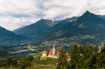 Fototapeta premium View of the village of St. George in South Tyrol with the bowl of the valley of Meran in the background